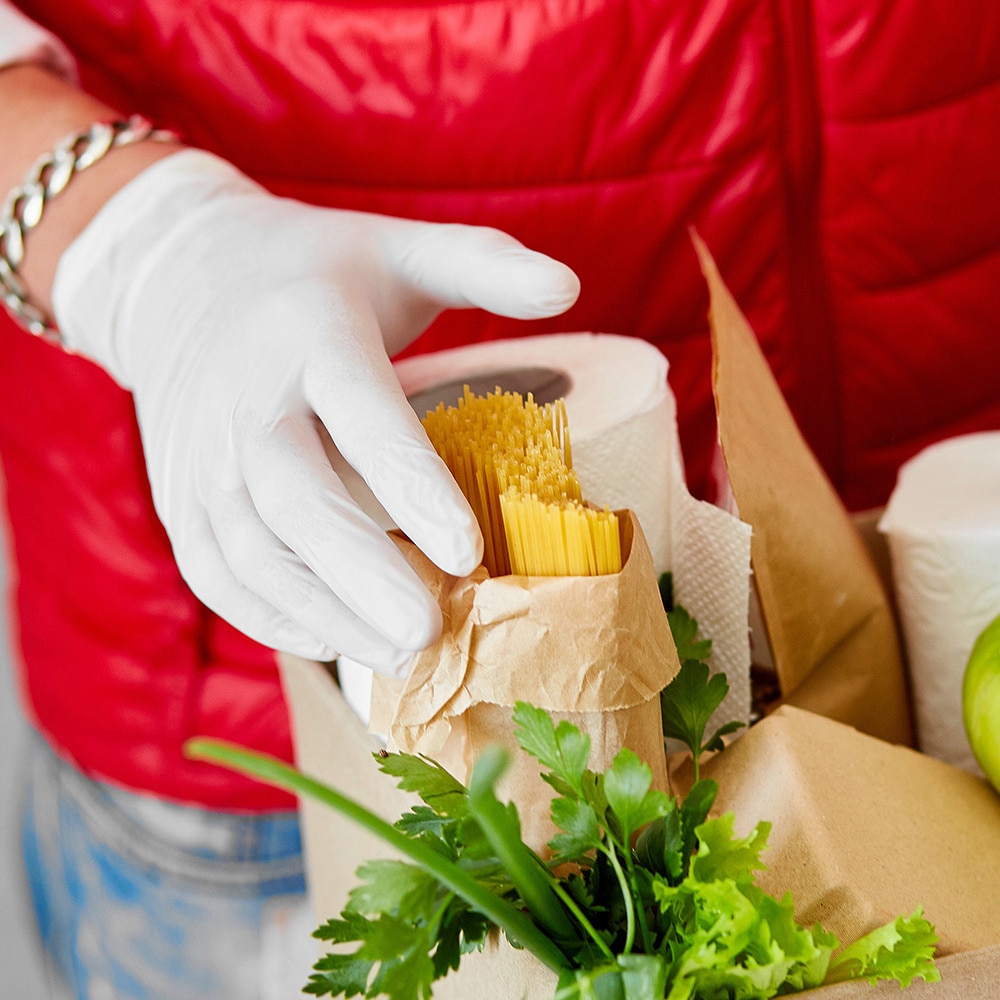 Gentleman wearing hand gloves, handling food