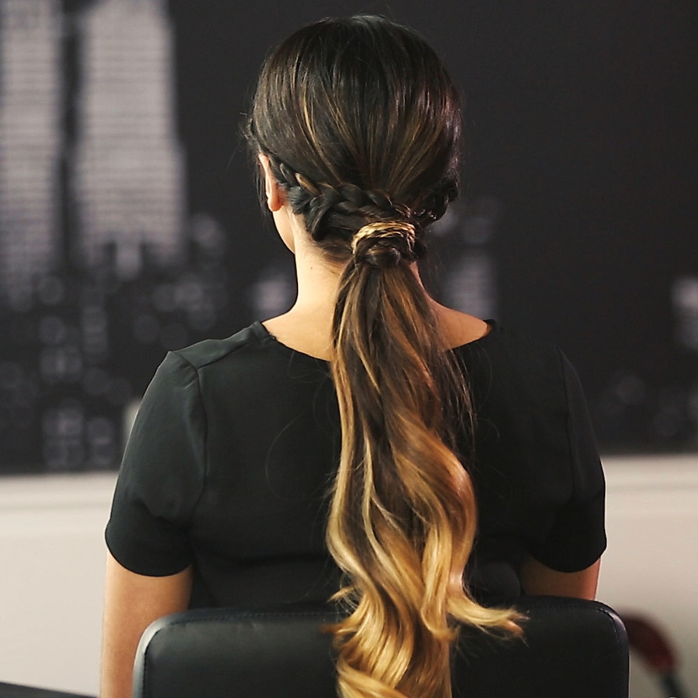 Model's hair styled into a braided low ponytail.