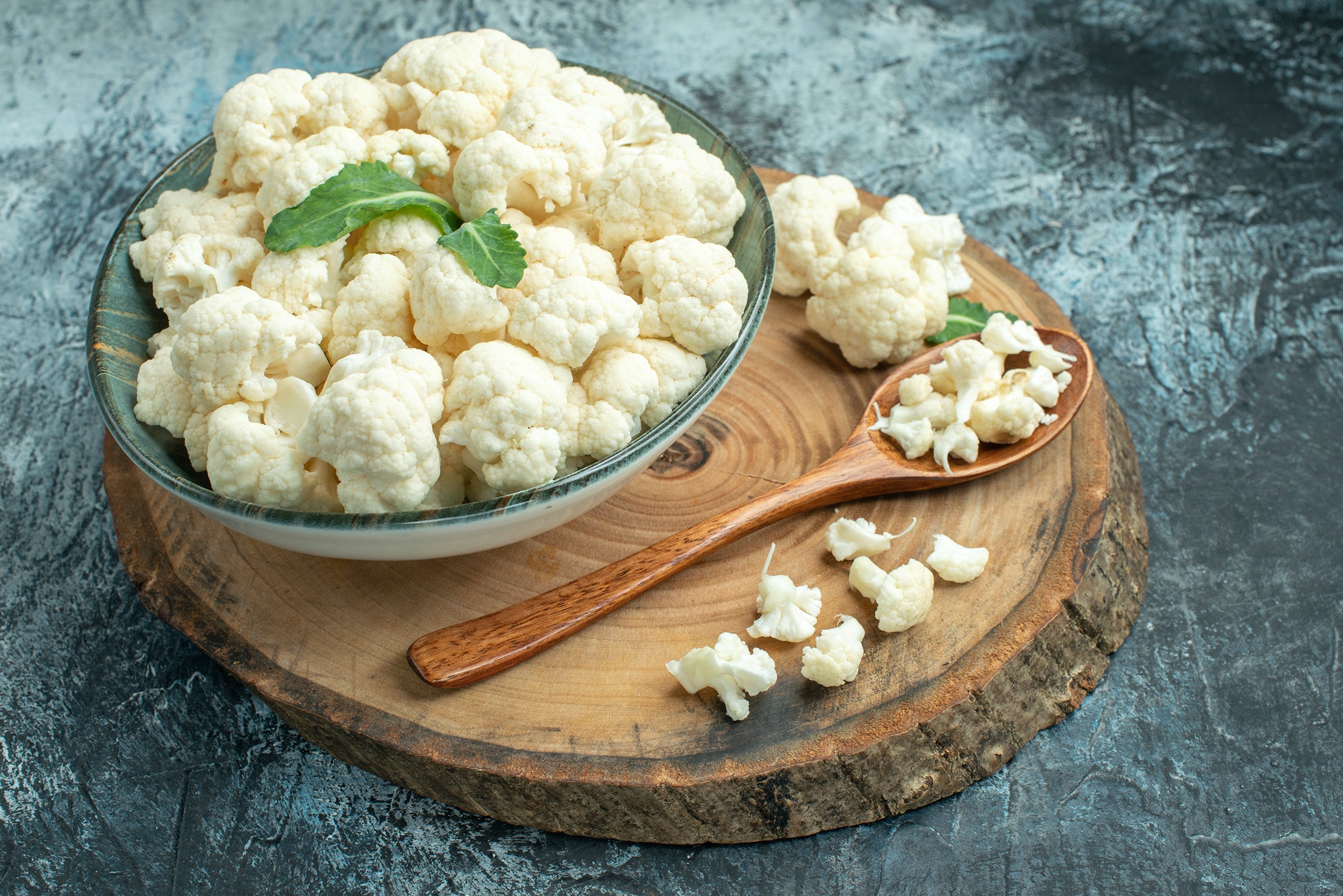 A bowl and spoon full of cauliflower florets