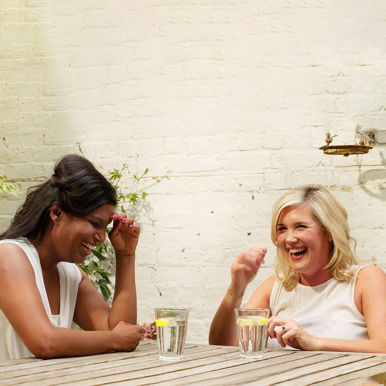 Two women sitting outside and laughing