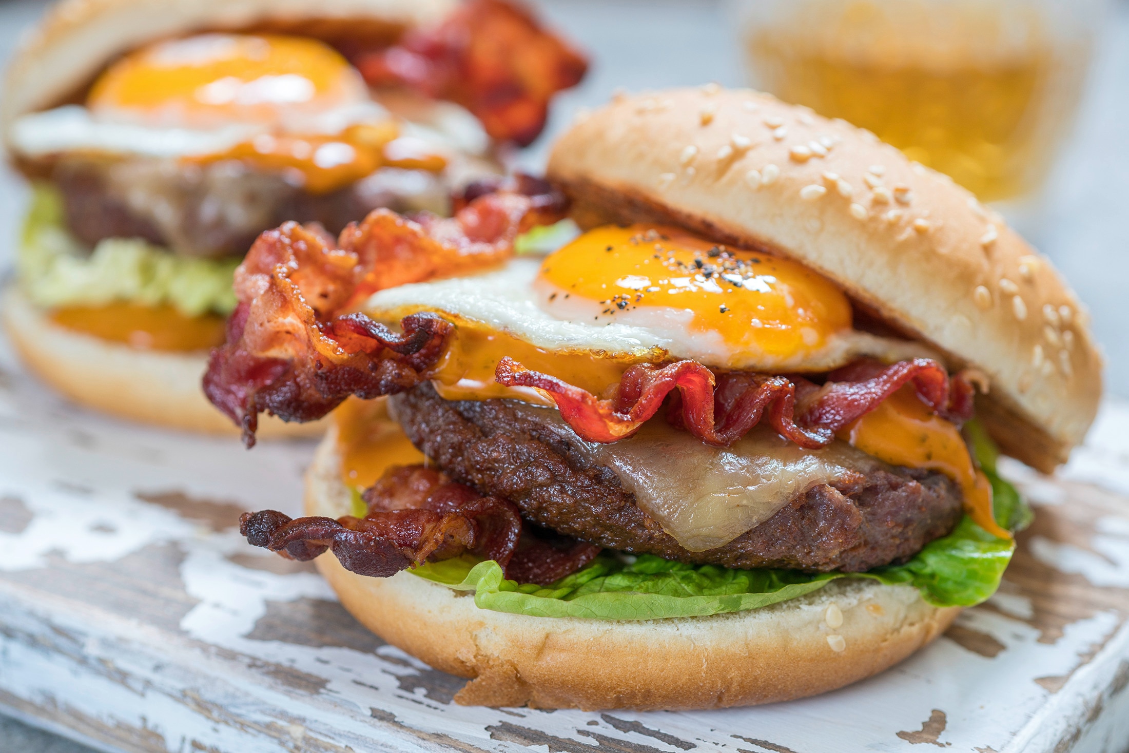 A burger with bacon, cheese, and egg